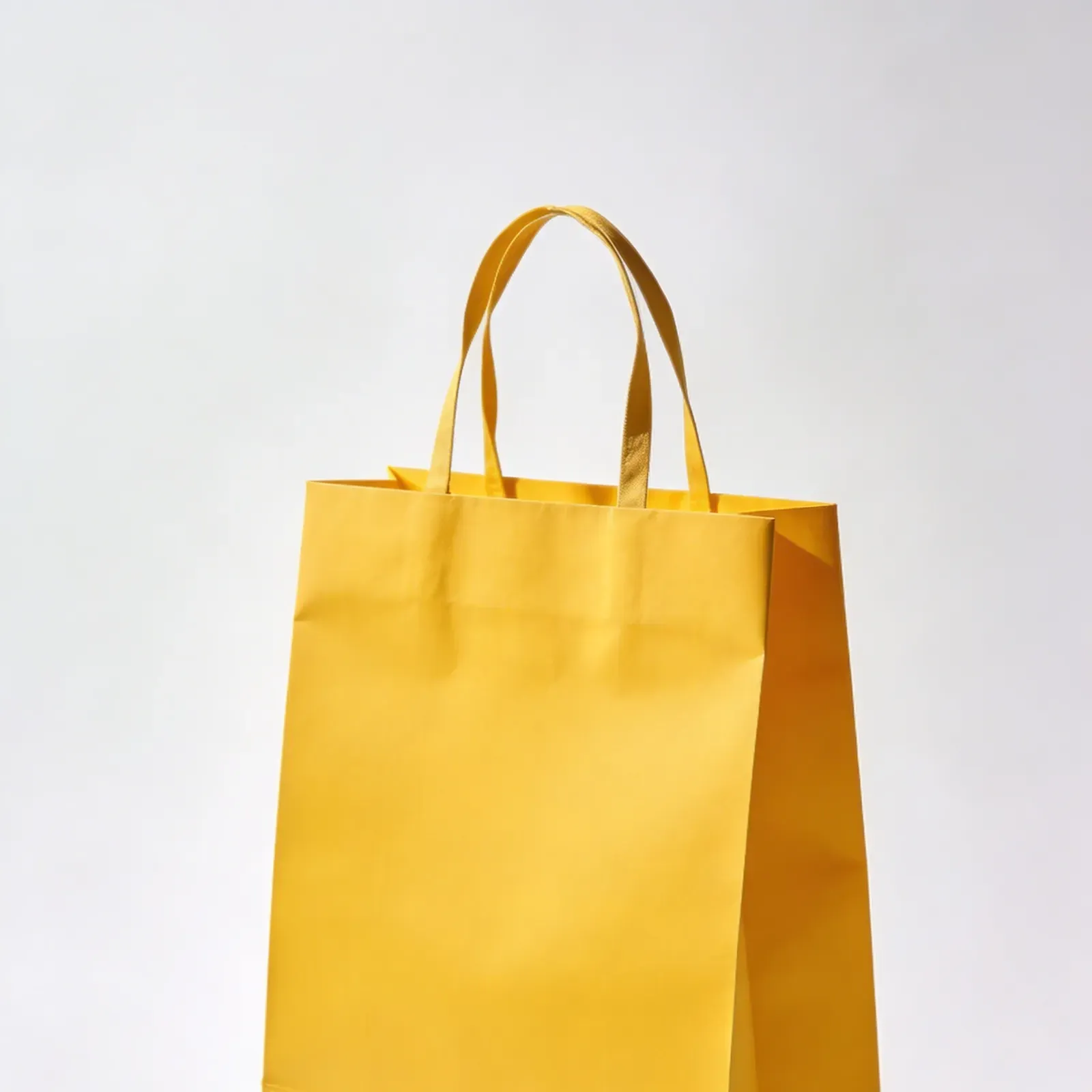 A yellow paper bag from the Karda launch kit, lit against white