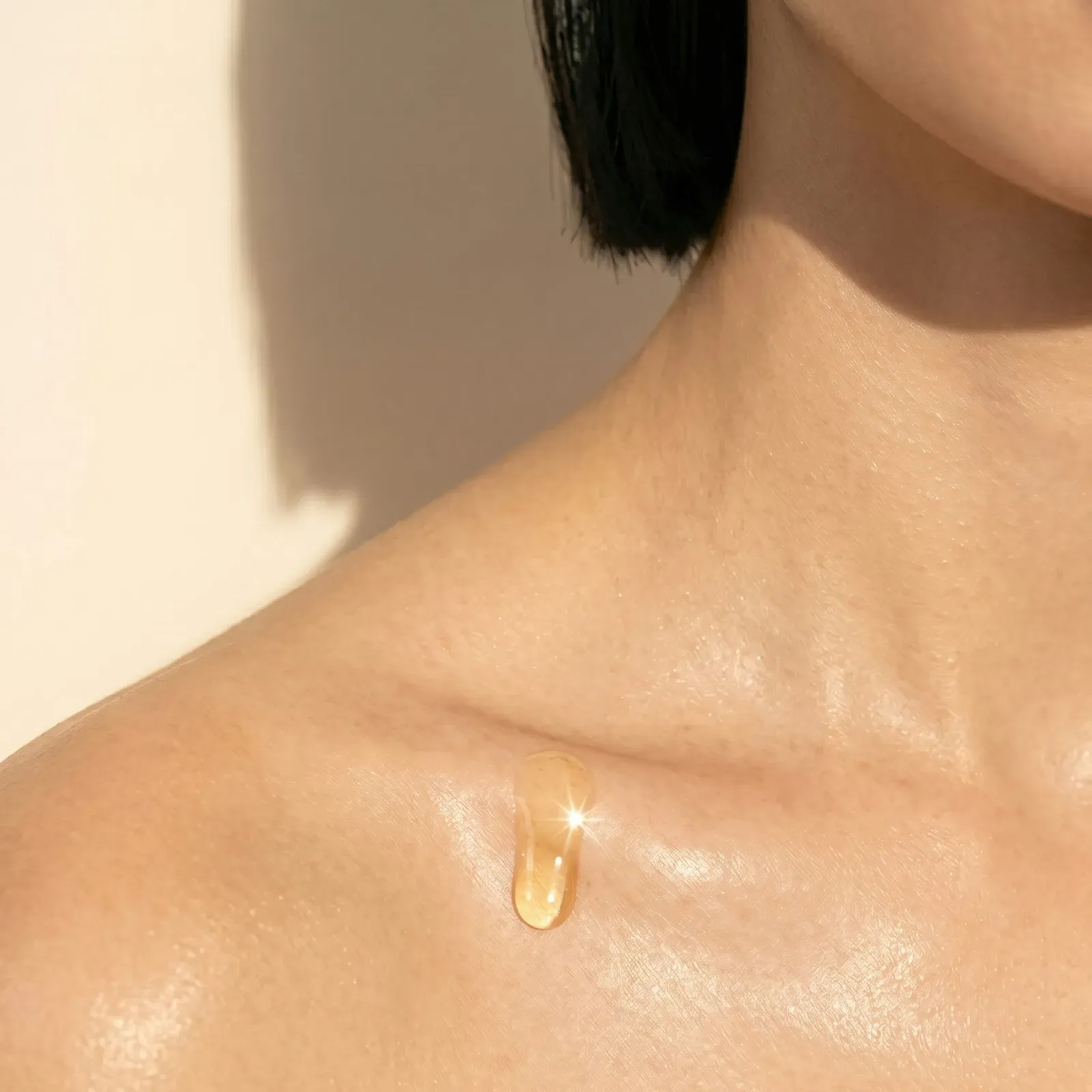 A drop of serum on skin, lit for the Oura product photography